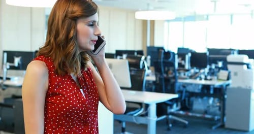 Woman Talking on Cell Phone in Modern Office
