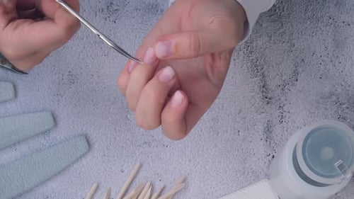 Manicurist Pushing Back Cuticles Close Up View