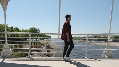 Youth Passing on Bridge Side View