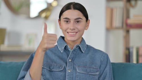 Woman Gives Thumbs Up of Approval Indoors