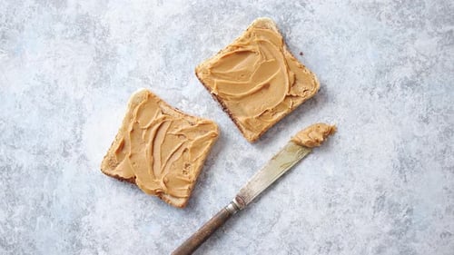 Two Tasty Peanut Butter Toasts Placed on Stone Table