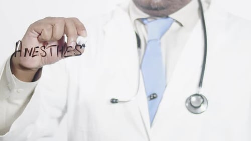Doctor Writing Anesthesia on Glass Surface