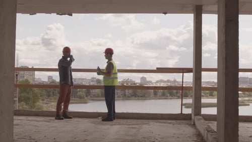 Workmen Talking on Construction Site