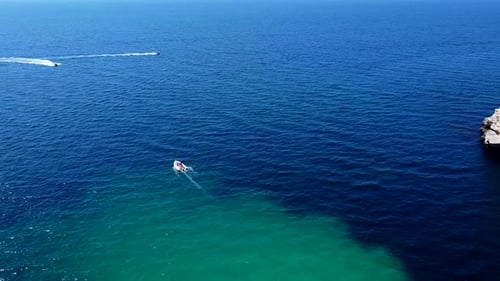 Aerial View of Tourist Boats Sailing on a Calm Sea with People on Board Enjoying the Beautiful Steep