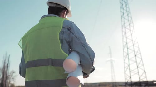Architect Worker Checking Construction Project On Electric Tower