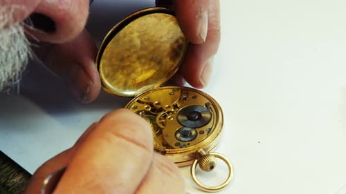 Adult Repairing Antique Golden Pocket Watch Close Up
