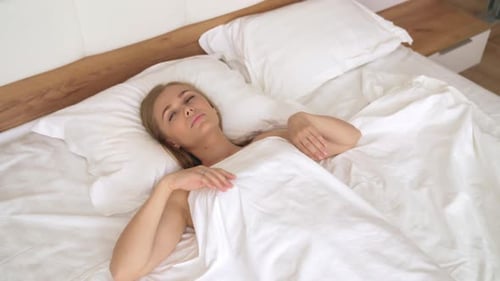 Fair Haired Woman Wakes Up and Stretches