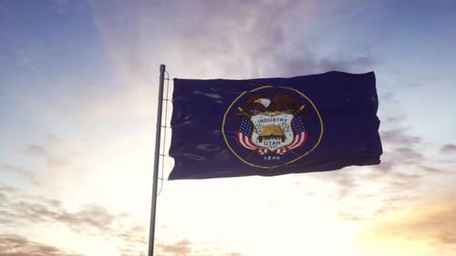 Waving Utah State Flag Against a Realistic Sunset Sky