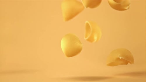 Super Slow Motion Pasta Rigate Dry Falls on the Table