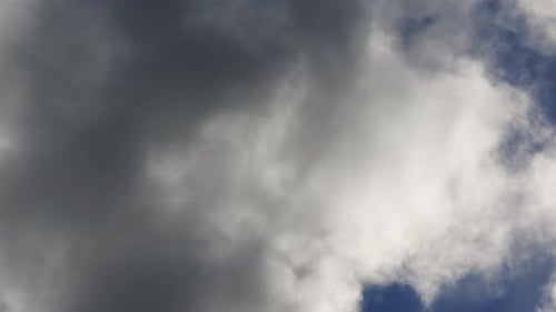 White And Grey Clouds Moving Through Blue Sky