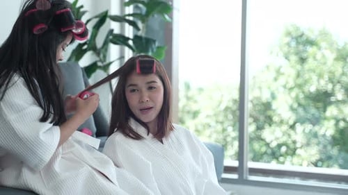 Young Woman Gets Hair Done By Child