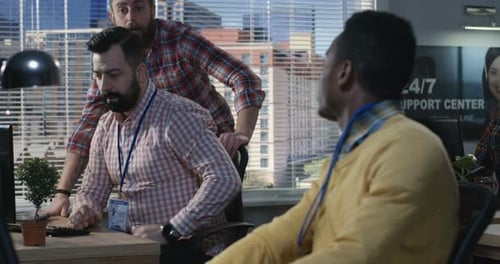 Young Office Workers Cooperating