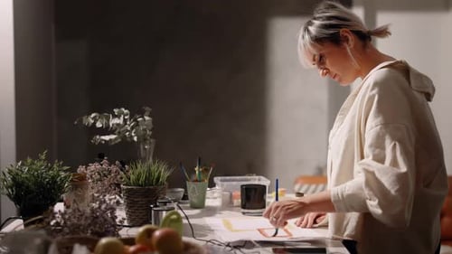 Woman Painting Colorful Squares on Paper Indoors