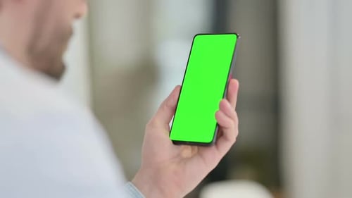 Rear View of Young Man Using Smartphone Chroma Screen