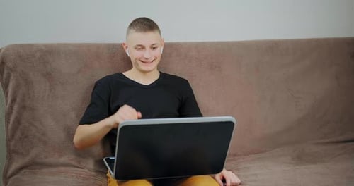Guy looks into black laptop display at online lesson