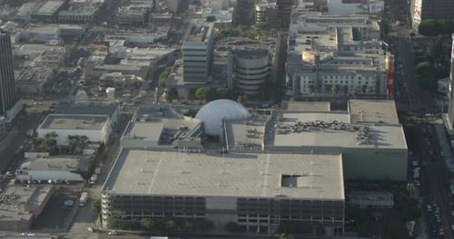 Helicopter aerial over urban residential area leading to freeways, hazy day