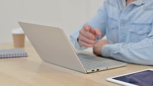 Finger Pointing at the Camera By Man Using Laptop Close Up