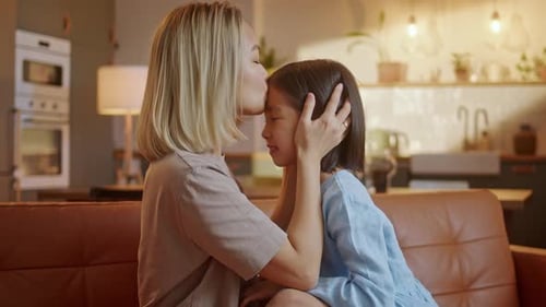 Happy Little Asian Cute Girl Hugging Embracing Her Mom Enjoying Bonding and Laughing Together