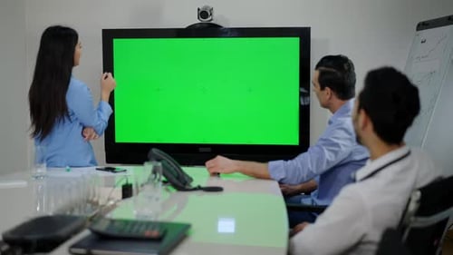 Big Chromakey Monitor in Modern Office with Thoughtful Multiethnic Coworkers Brainstorming