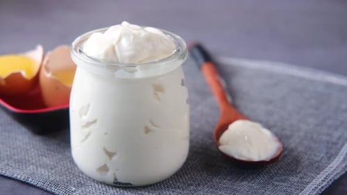 Close Up of Mayonnaise in Container on Table