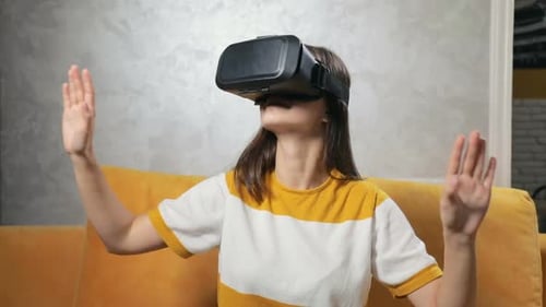 Woman Using Virtual Reality Headset on Couch