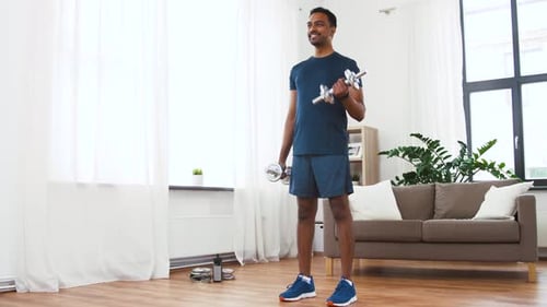 Indian Man Exercising with Dumbbells at Home
