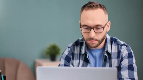 Bearded Man in Glasses Chatting Use Laptop at Home Office