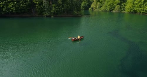 Young Couple In A Boat On The Background Of A Lake