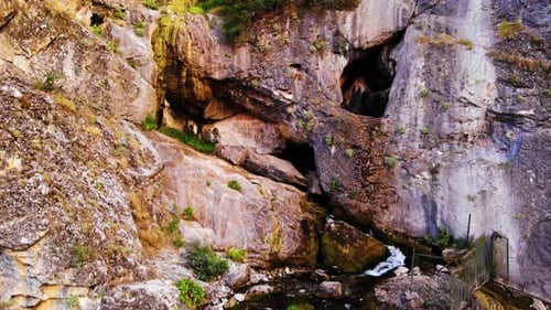 Scenic Waterfall Flowing Down Rocky Cliffside