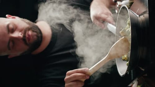 Vertical Video of Chef Frying Green Brussels Sprouts Cabbage in Pan Closeup