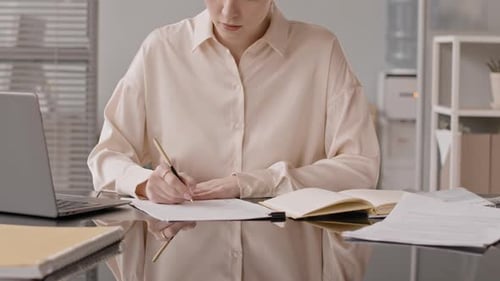 Female HR Manager Taking Notes during Video Job Interview
