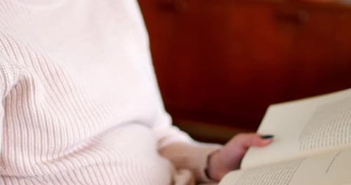 Young Woman Reading a Book Indoors