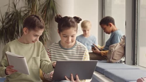 Girls Using Laptop in School