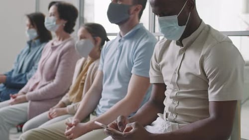 Multiethnic People In Hospital Queue