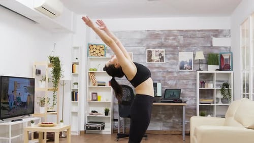 Woman Practicing Yoga in a Living Room