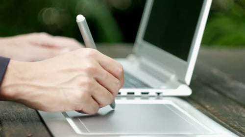 Artist Using a Digital Tablet and Stylus