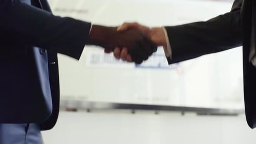 Business Handshake Between Two Men in Suits