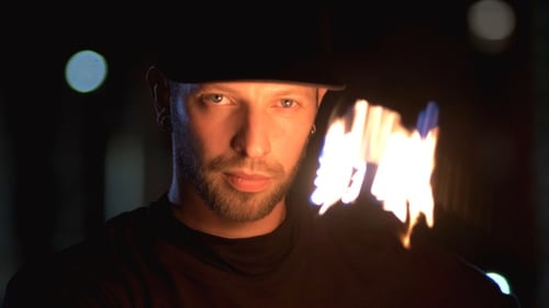 Man Juggling Flames at Night, Close Up