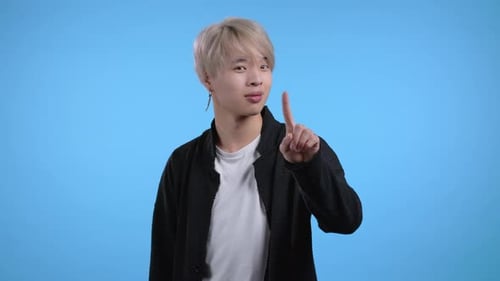 Portrait of Serious Korean Man Showing Rejecting Gesture By Stop Finger Sign