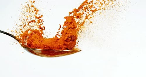 Turmeric, curcuma longa, Root falling on curcuma Powder, Indian Spice, Slow Motion 4K