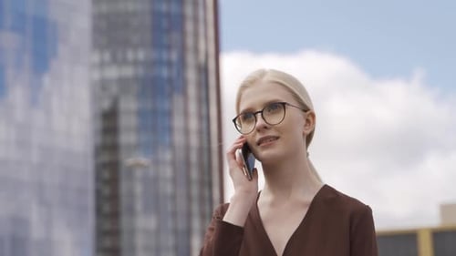 Businesswoman Talking on Phone in City Environment