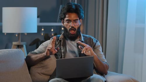 Young Adult Working on Laptop at Night