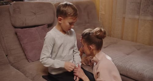 Boy and Woman Looking at Mobile Phone Indoors