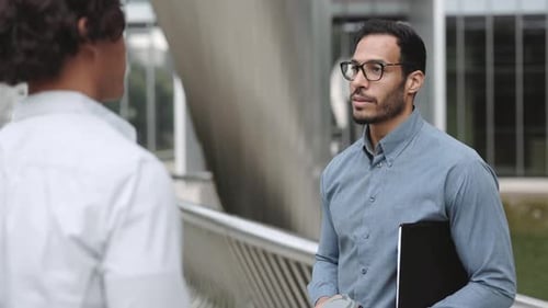 Business Meeting and Handshake on City Walkway