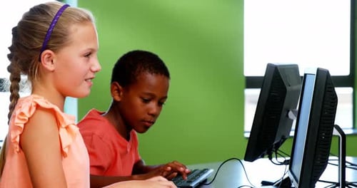 School kids using computer in classroom
