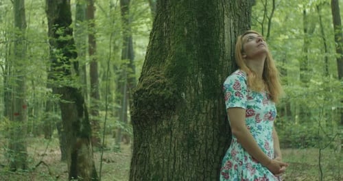 Dreamy Woman Near Trees