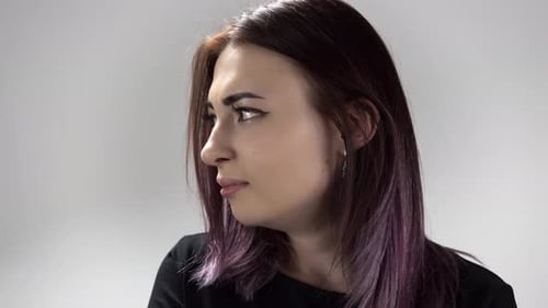 Auburn Haired Woman with Purple Highlights Looking Down