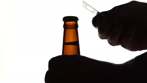 Silhouetted Figure Opens a Bottle with Knife
