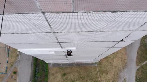 Industrial Alpinism. Aerial View. Work on Outer Insulate Building with Styrofoam