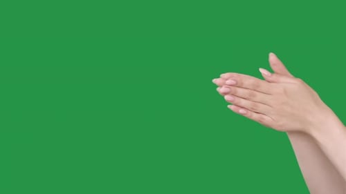 Woman's hands clapping on a green background